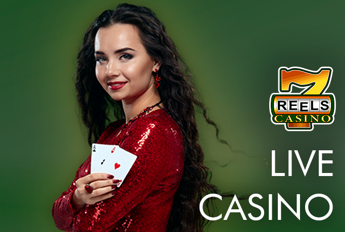 Beautiful live-dealer woman in red dress holding two playing cards and 7Reels logo