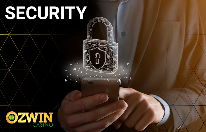 Man holding smartphone and a hologram of lock and Ozwin Casino logo